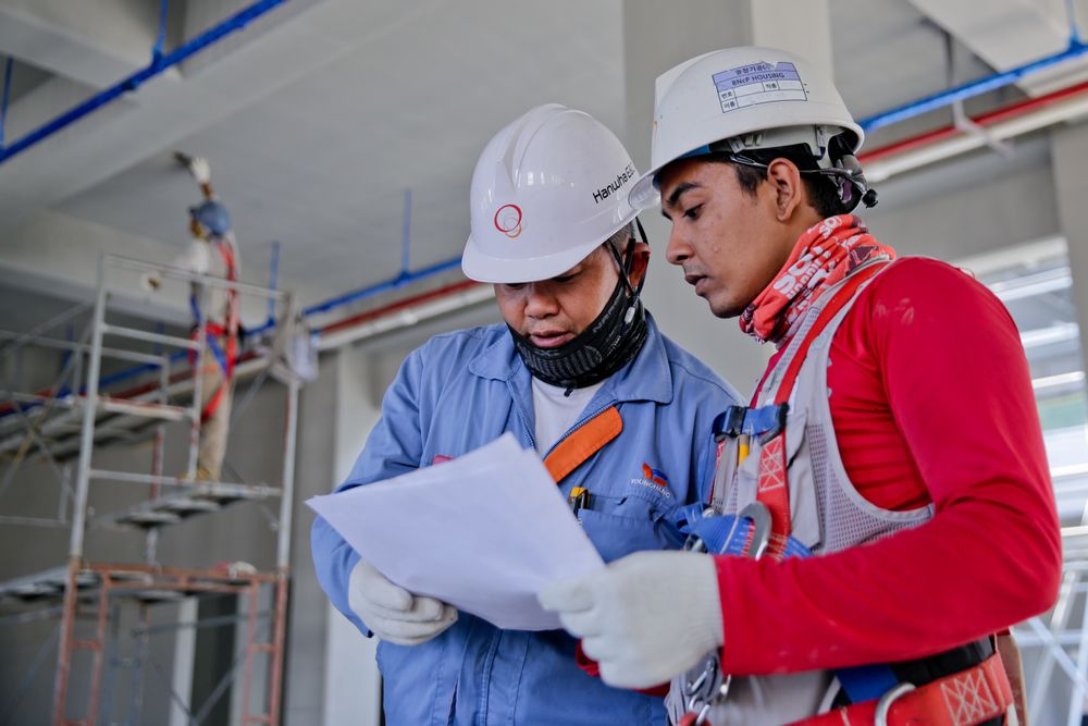 Avrio project managers reviewing construction drawings on site